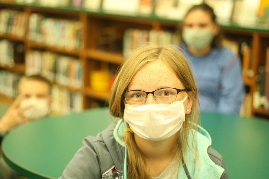 Freshman Sophia Jeffery sits masked at a music club meeting. Students are required to wear masks during the school day as well as during extracurricular activities.