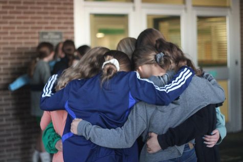 Junior high girls huddle up in prayer