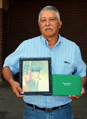 Joe Meza proudly displays his newly-awarded high school diploma alongside a photo of himself in the army. Meza has waited 50 years to receive his diploma after being drafted his junior year to serve in Vietnam.