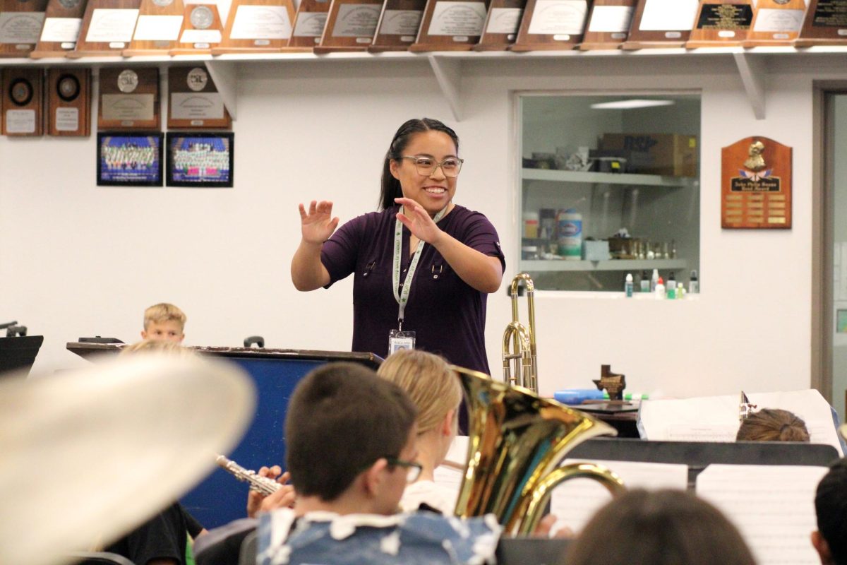 New band director Gabby Nguyen leads seventh grade band students in warmups at the beginning of practice.