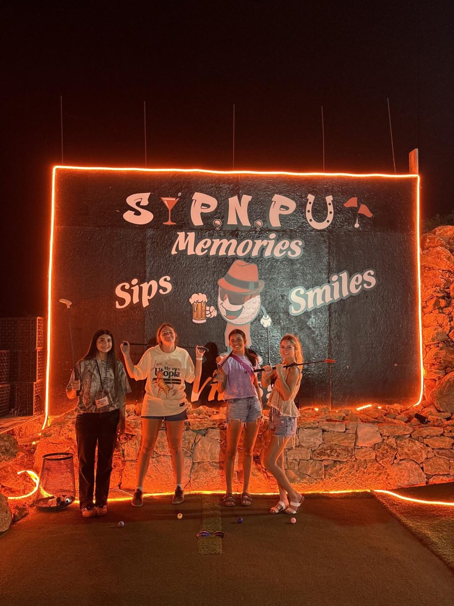 Juniors Klaryssa Cereceres, Kelby Barton, Lily Lawson and senior Ella Hogg pose in front of the sign during a round of mini golf one evening during the ILPC Summer Workshop at Texas State University in San Marcos. (Photo courtesy of Lily Lawson.)